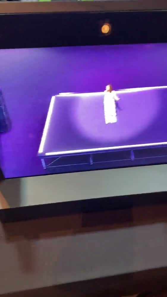 A volumetric capture stage lit in magenta at Immerse Global Summit, with a performer standing at its centre