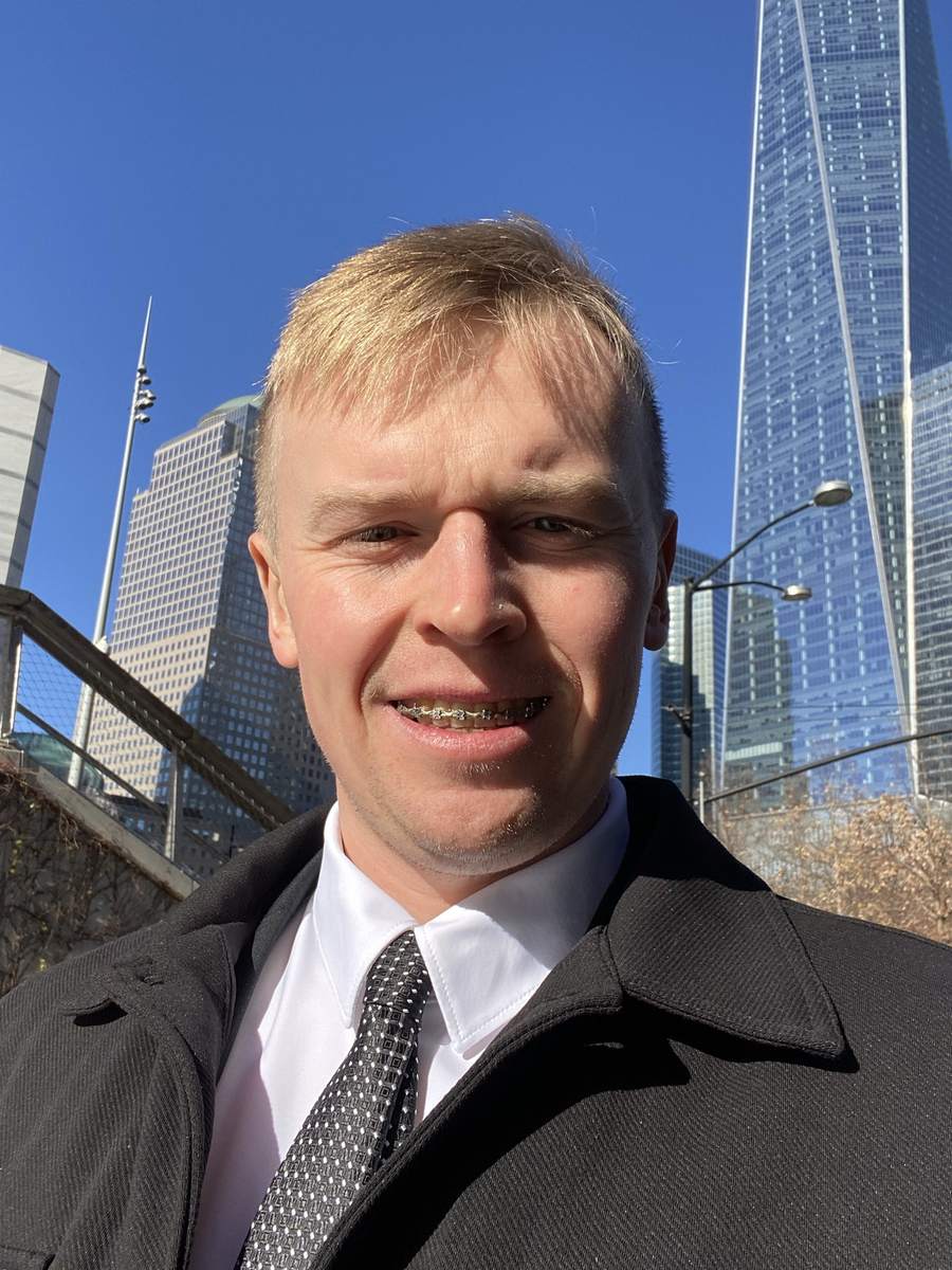A Fluvius founder in New York's financial district, One World Trade Center behind