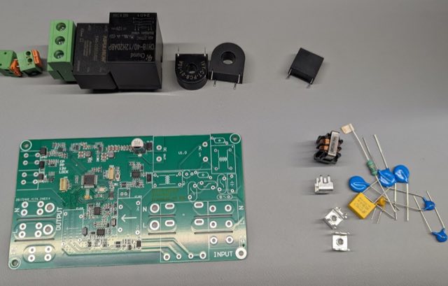Bare printed circuit board with its components laid out around it