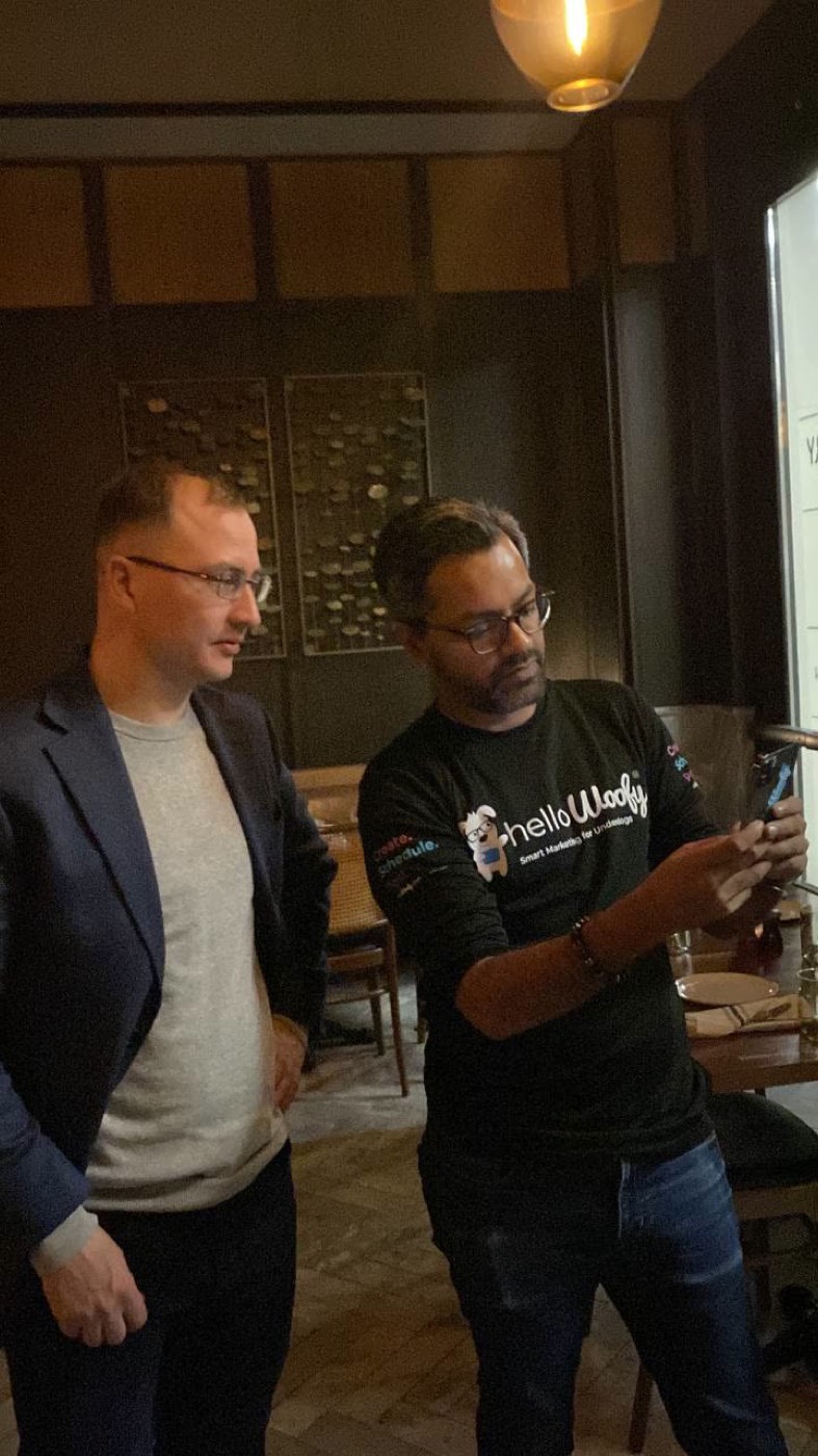 Two Fluvius engineers testing a live build on a phone during a client visit in New York
