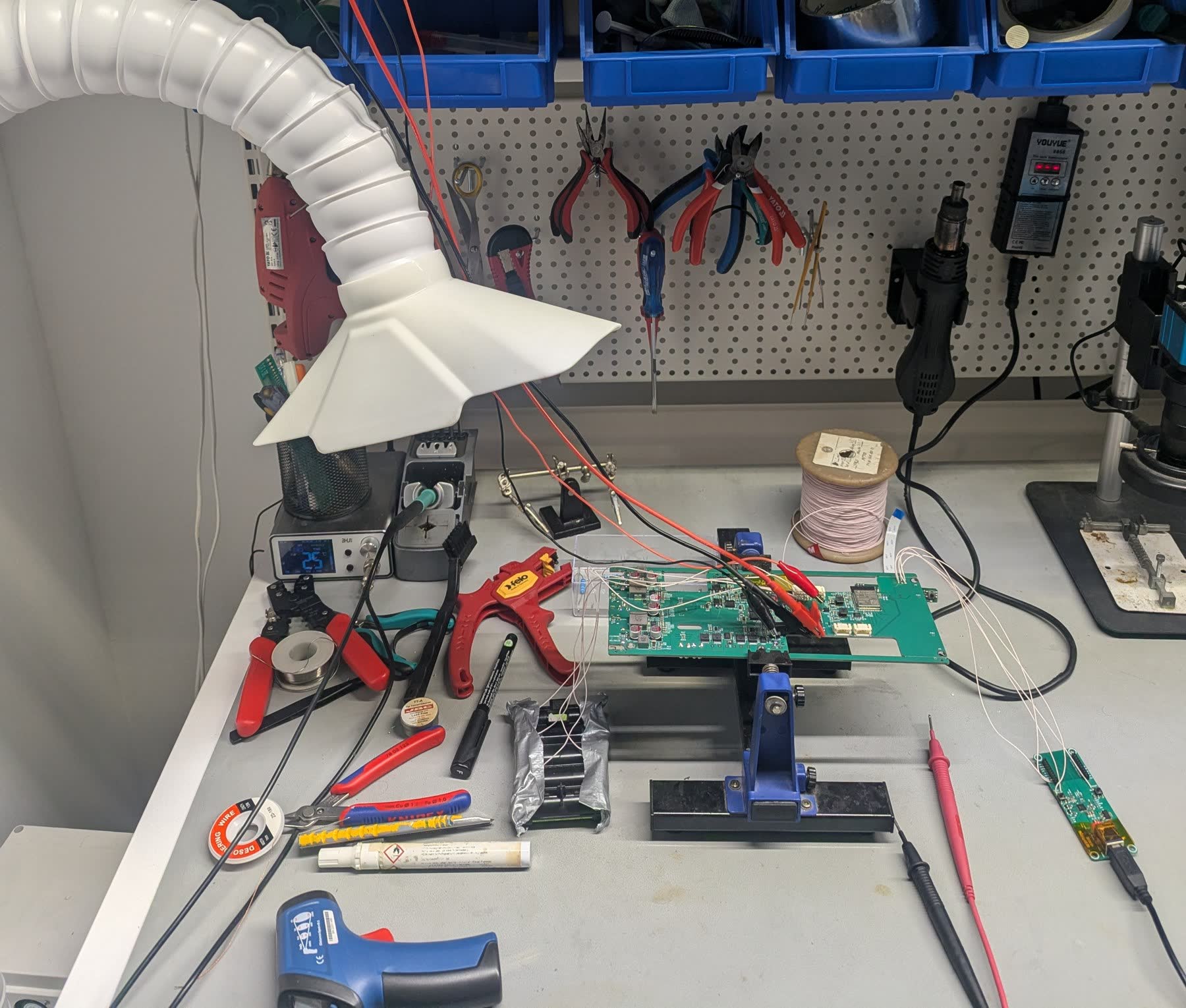 A board under test on the bench in our hardware lab, with probes and a wire harness attached